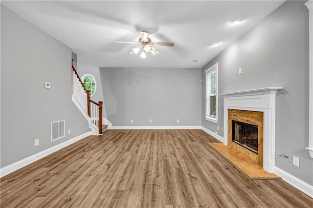 1714 Boulder Walk Ln SE, Atlanta, GA 30316 - unfurnished living room featuring plenty of natural light, ceiling fan, light wood-style floors, and baseboards