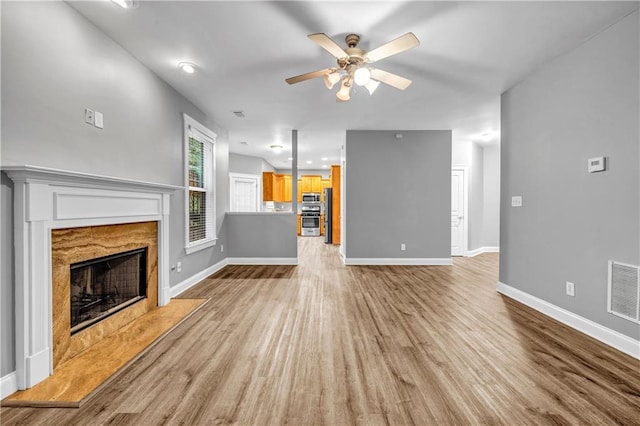 1714 Boulder Walk Ln SE, Atlanta, GA 30316 - unfurnished living room with a ceiling fan, wood finished floors, baseboards, and a premium fireplace