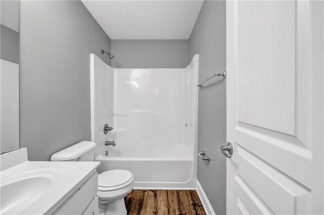 1714 Boulder Walk Ln SE, Atlanta, GA 30316 - bathroom featuring wood finished floors, toilet, vanity, and bathtub / shower combination