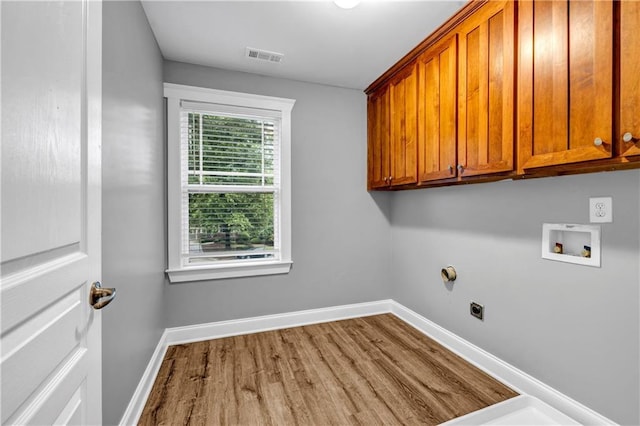 1714 Boulder Walk Ln SE, Atlanta, GA 30316 - laundry room with cabinet space, hookup for an electric dryer, wood finished floors, baseboards, and hookup for a washing machine