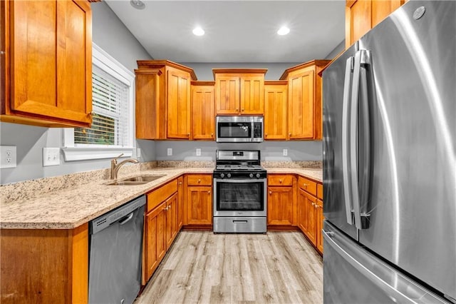 1714 Boulder Walk Ln SE, Atlanta, GA 30316 - kitchen with appliances with stainless steel finishes, a sink, light wood-style flooring, brown cabinetry, and recessed lighting