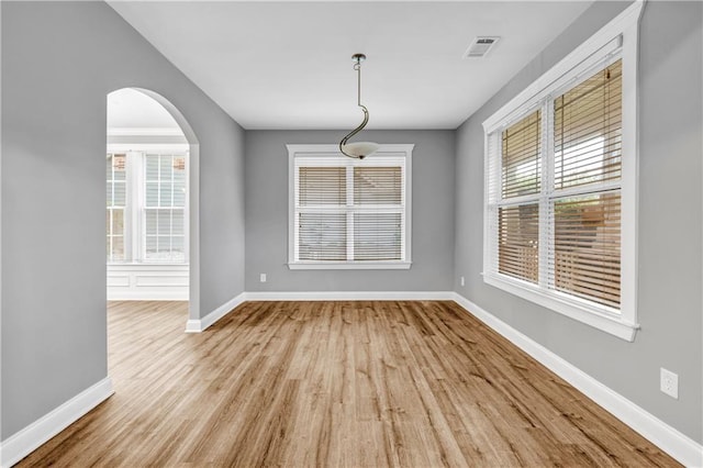 1714 Boulder Walk Ln SE, Atlanta, GA 30316 - unfurnished dining area featuring baseboards, wood finished floors, and arched walkways