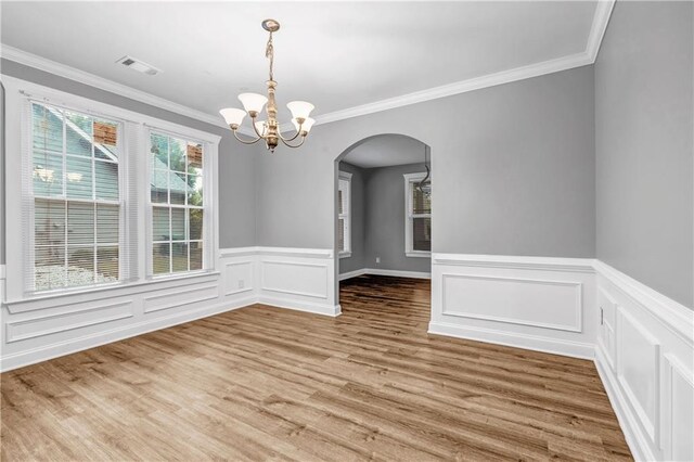 1714 Boulder Walk Ln SE, Atlanta, GA 30316 - unfurnished dining area featuring arched walkways, a chandelier, crown molding, wood finished floors, and wainscoting