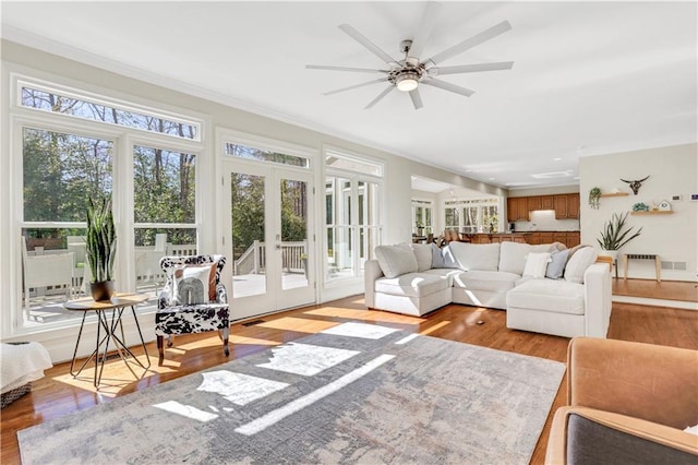 sunroom featuring a ceiling fan, french doors, and visible vents