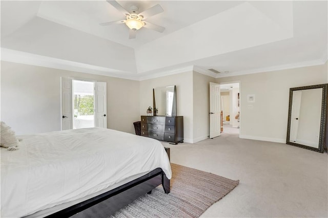 bedroom with a tray ceiling, baseboards, light colored carpet, and crown molding