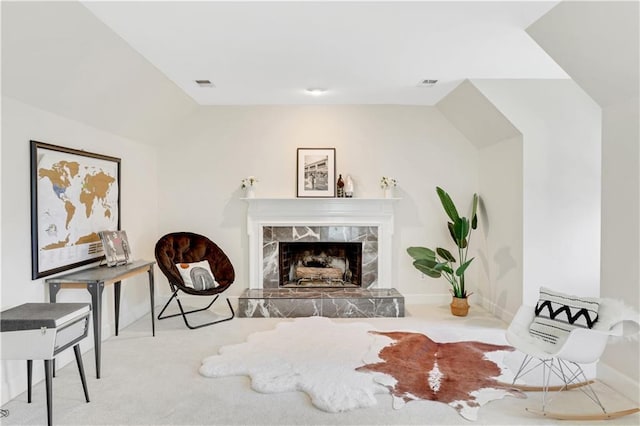 living area featuring visible vents, baseboards, and a fireplace