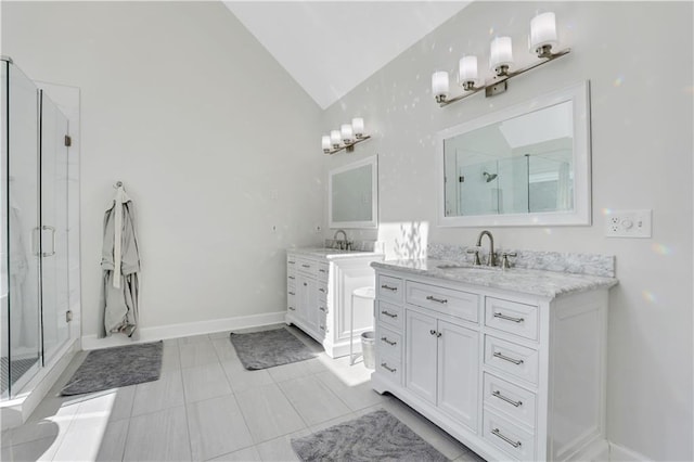 full bathroom featuring a sink, two vanities, a stall shower, and vaulted ceiling