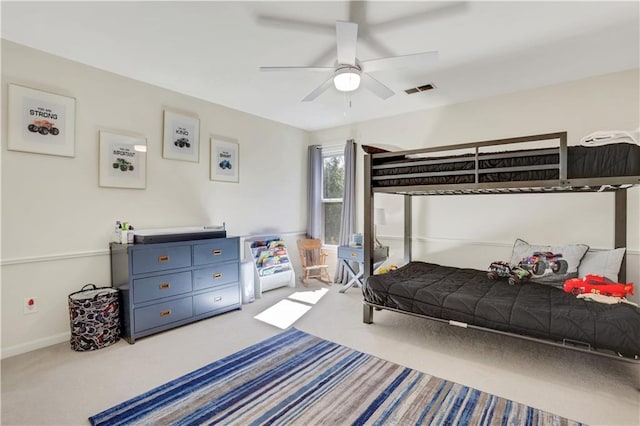 bedroom with a ceiling fan, visible vents, carpet floors, and baseboards