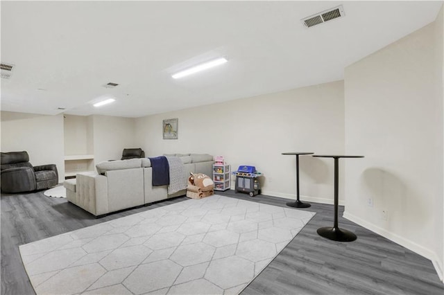 interior space with visible vents, baseboards, and wood finished floors