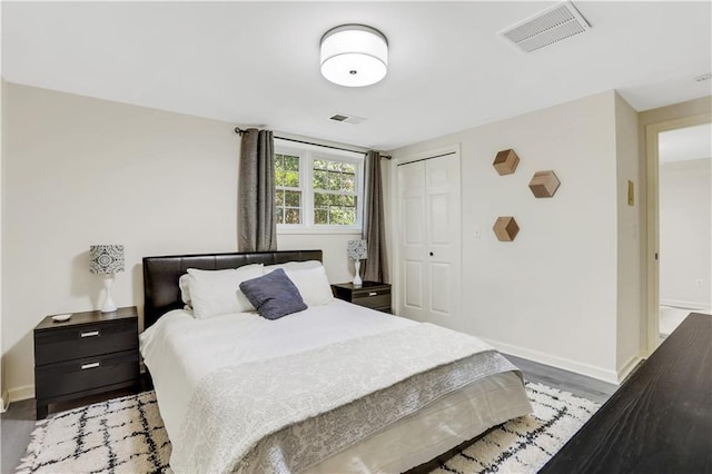 bedroom with a closet, visible vents, and baseboards