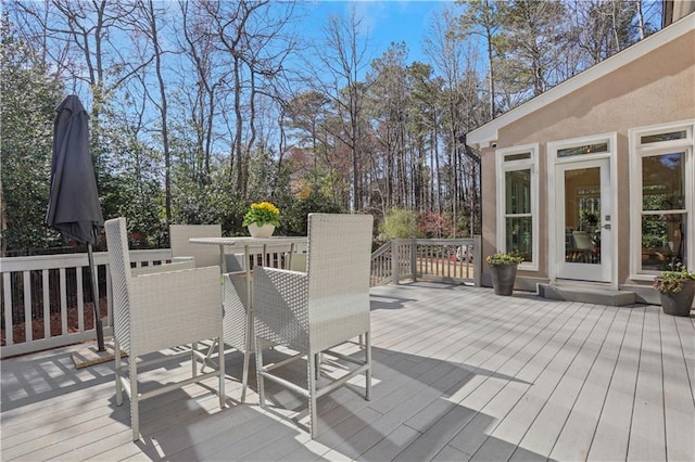 wooden terrace with outdoor dining area