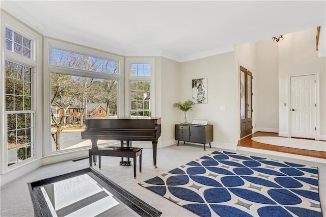 interior space featuring crown molding, baseboards, and light carpet