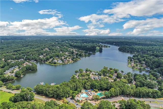 drone / aerial view featuring a water view and a view of trees