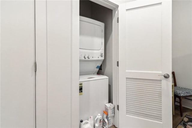 laundry area featuring stacked washer and dryer and laundry area