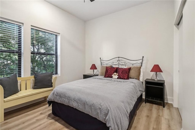 bedroom featuring baseboards and wood finished floors