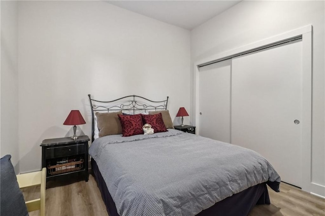 bedroom featuring light wood-type flooring and a closet