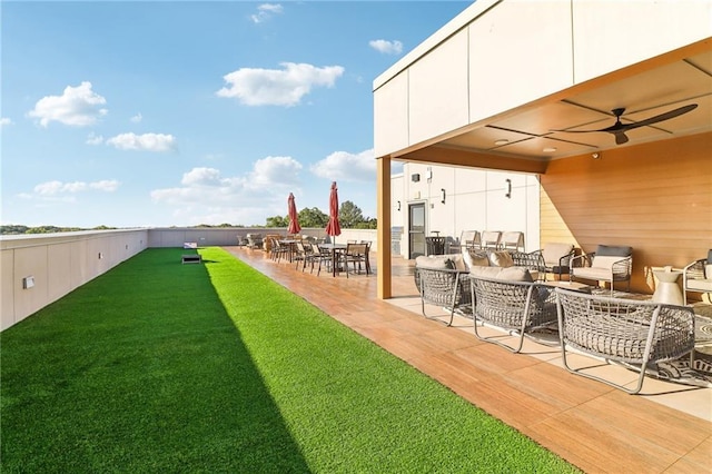 view of yard featuring outdoor dining space, a patio area, ceiling fan, and an outdoor living space