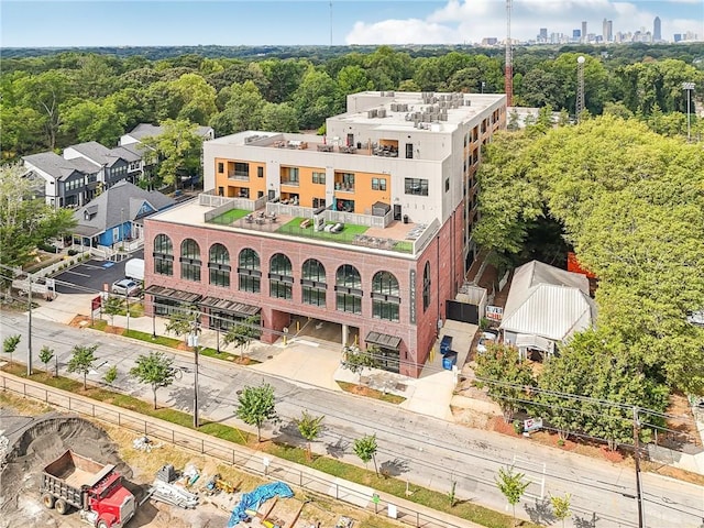 bird's eye view with a wooded view