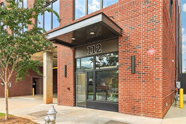 property entrance featuring brick siding