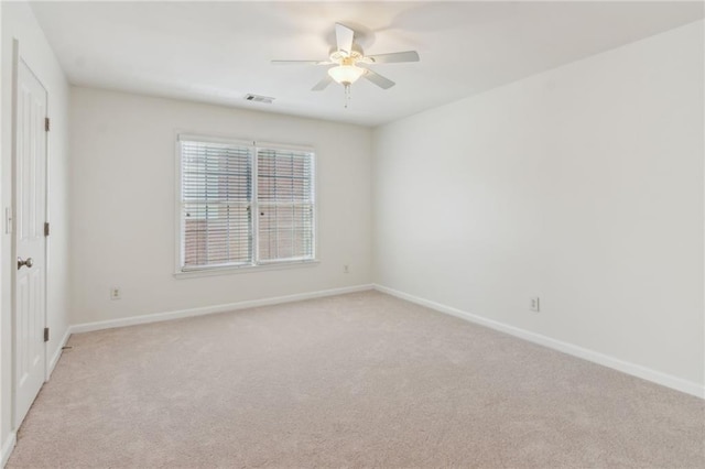 carpeted spare room with ceiling fan