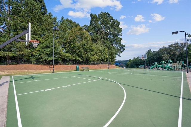 view of basketball court with a playground