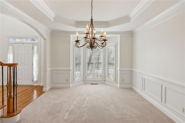 interior space featuring crown molding, carpet flooring, and a tray ceiling