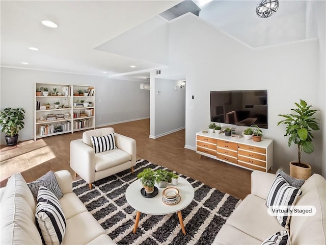 living area featuring baseboards, vaulted ceiling, wood finished floors, and recessed lighting