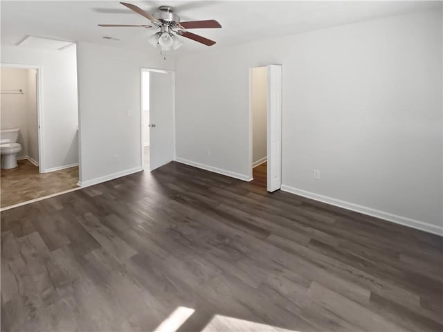 unfurnished bedroom with baseboards, visible vents, a ceiling fan, dark wood-style flooring, and ensuite bathroom