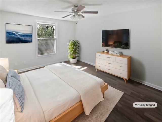 bedroom featuring dark wood-style flooring, a ceiling fan, and baseboards