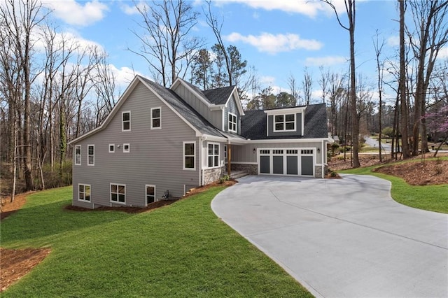 view of home's exterior featuring concrete driveway, a lawn, and a garage