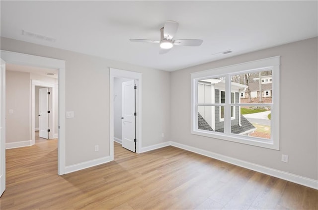 unfurnished bedroom featuring visible vents, a spacious closet, baseboards, and light wood-type flooring