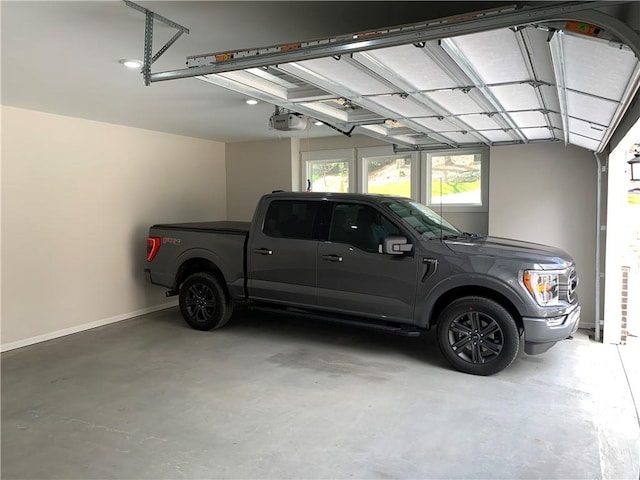 garage with baseboards and a garage door opener