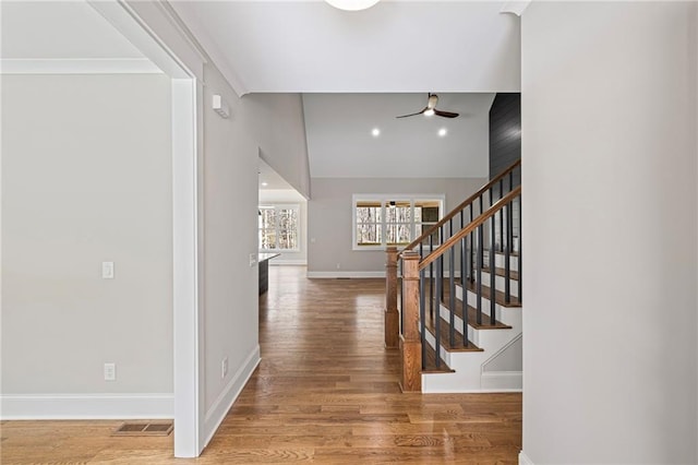 entrance foyer with visible vents, baseboards, ceiling fan, and wood finished floors