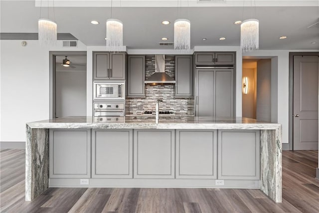 3630 Peachtree Rd NE Unit 2207, Atlanta, GA 30326 - kitchen with wall chimney range hood, built in appliances, gray cabinets, tasteful backsplash, and recessed lighting