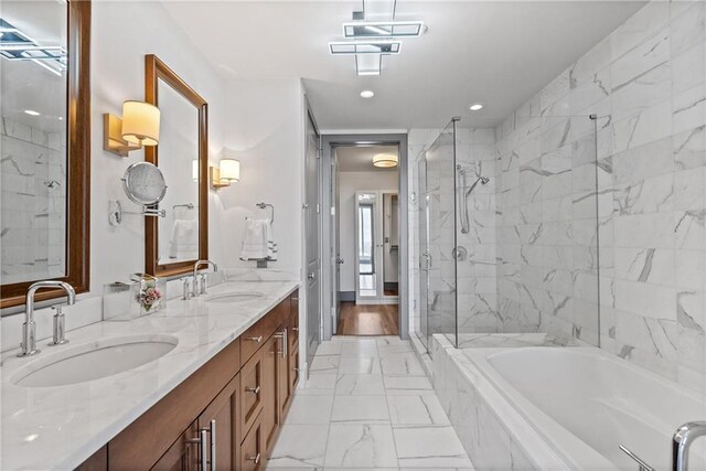 3630 Peachtree Rd NE Unit 2207, Atlanta, GA 30326 - full bath with marble look tile flooring, a bath, a marble finish shower, double vanity, and recessed lighting