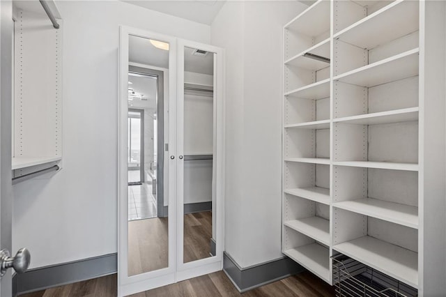 3630 Peachtree Rd NE Unit 2207, Atlanta, GA 30326 - walk in closet with dark wood finished floors