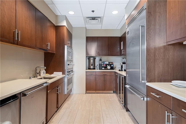 3630 Peachtree Rd NE Unit 2207, Atlanta, GA 30326 - kitchen with built in appliances, a sink, a paneled ceiling, light countertops, and recessed lighting