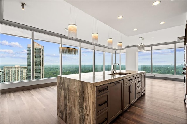 3630 Peachtree Rd NE Unit 2207, Atlanta, GA 30326 - kitchen with a sink, plenty of natural light, light stone countertops, dark wood-type flooring, and recessed lighting