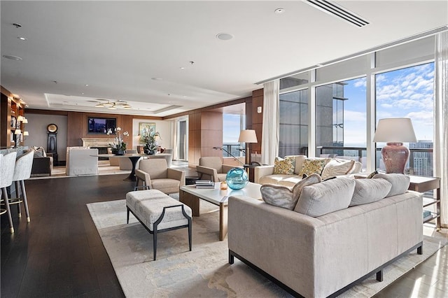 3630 Peachtree Rd NE Unit 2207, Atlanta, GA 30326 - living area featuring a tray ceiling, a wall of windows, wood finished floors, recessed lighting, and ceiling fan