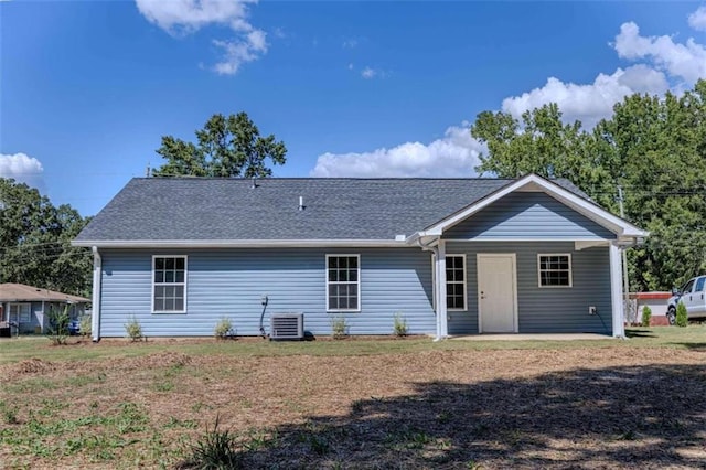 back of house with central AC