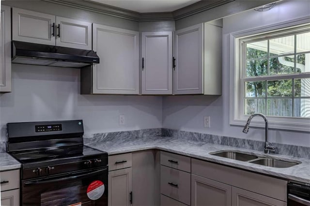 kitchen featuring light stone countertops, dishwasher, black range, and sink