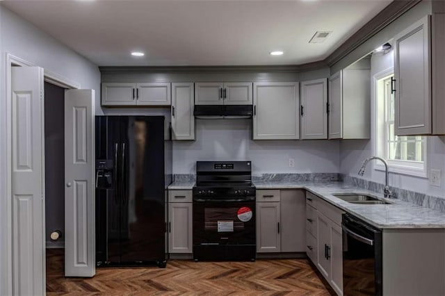 kitchen featuring black appliances, gray cabinetry, and sink