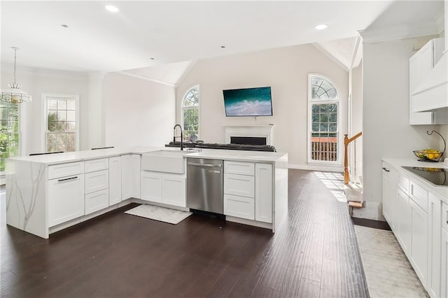 kitchen with white cabinetry, decorative light fixtures, dishwasher, and sink