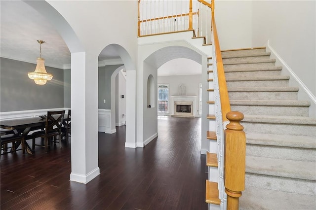 entryway featuring a high ceiling and dark hardwood / wood-style flooring