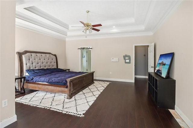 bedroom with crown molding, ceiling fan, a raised ceiling, and hardwood / wood-style flooring