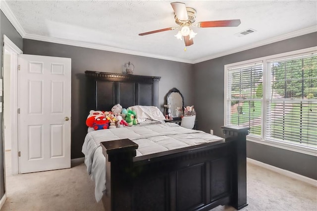 bedroom featuring crown molding, light colored carpet, and ceiling fan