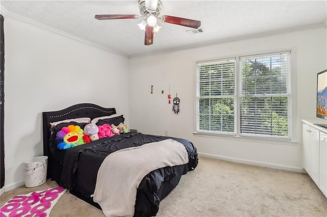 bedroom with multiple windows, crown molding, light colored carpet, and ceiling fan