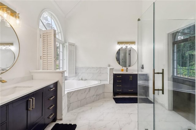 bathroom with vanity and tiled bath