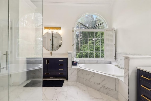 bathroom featuring vanity, independent shower and bath, and a wealth of natural light