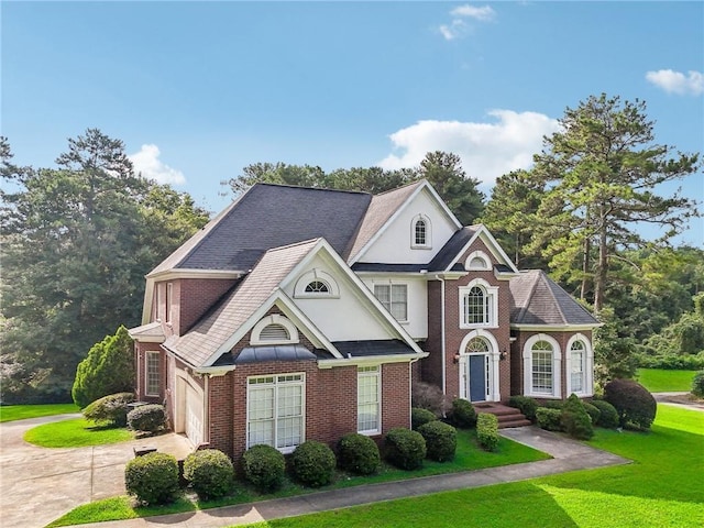 view of front of home featuring a garage and a front lawn